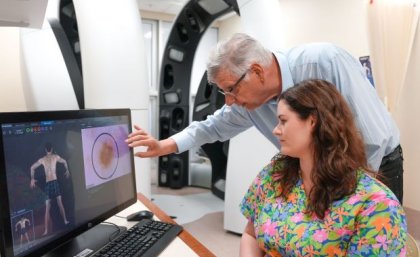 Researchers studying skin lesions on computer image. Credit, UQ 